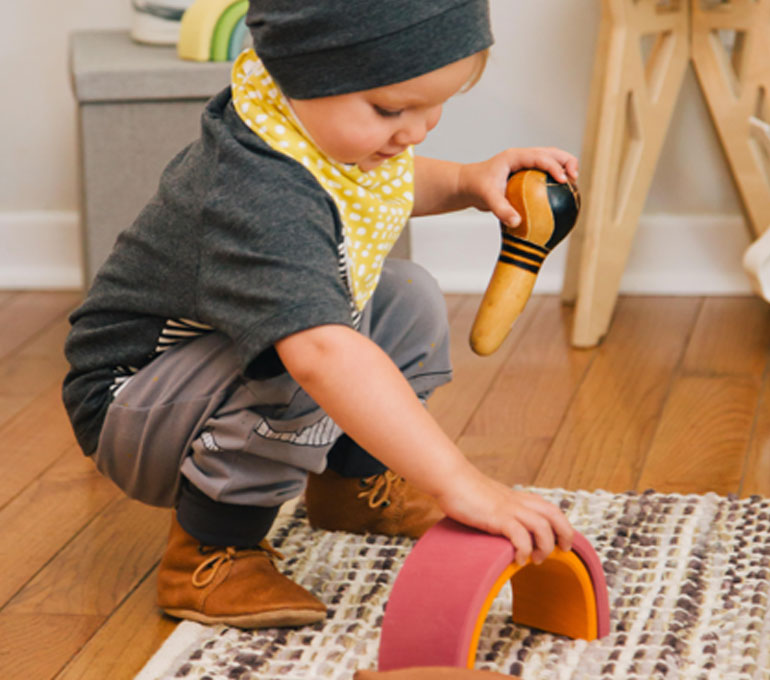 Explore Childrens baby playing in colorful ethical clothing