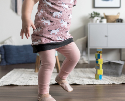 Young child in blush leggings and a confetti tunic